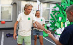 Boy and girl handing out notes at an event